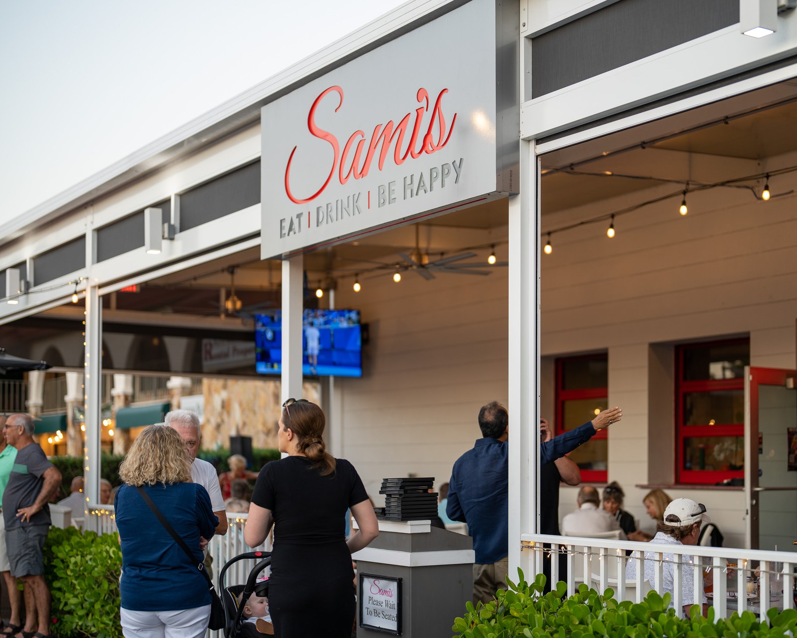 Sami's patio with guests enjoying live music